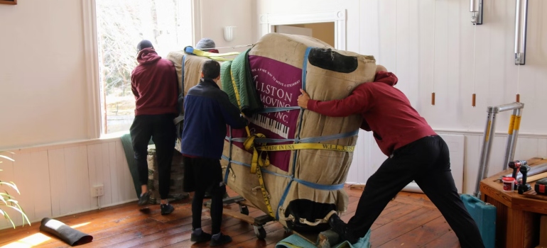 A group of people carrying a large object