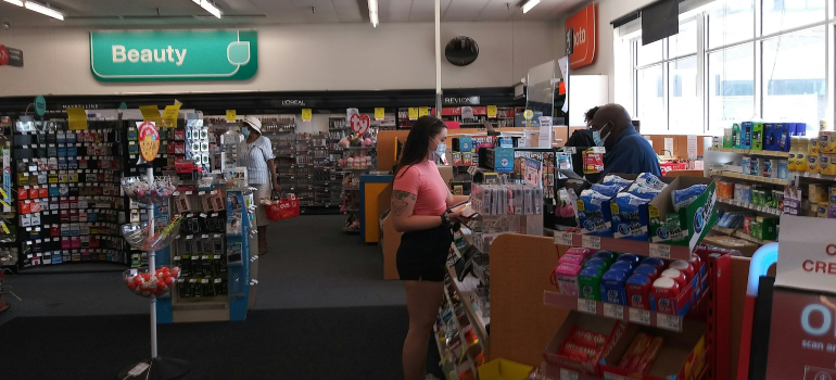 People in an convenience store talking about what you need to know before moving long distance from Philadelphia