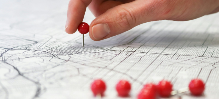 Person putting pins on a map