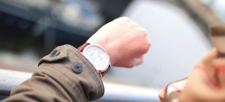 person looking at their watch, what most people forget during a rush move is that there isn't a lot of time