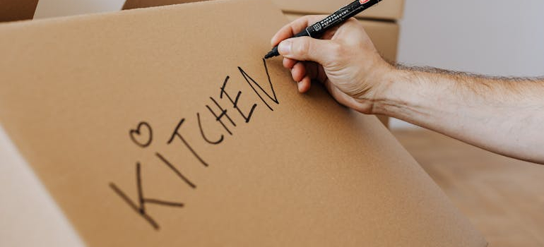 a person labeling a box