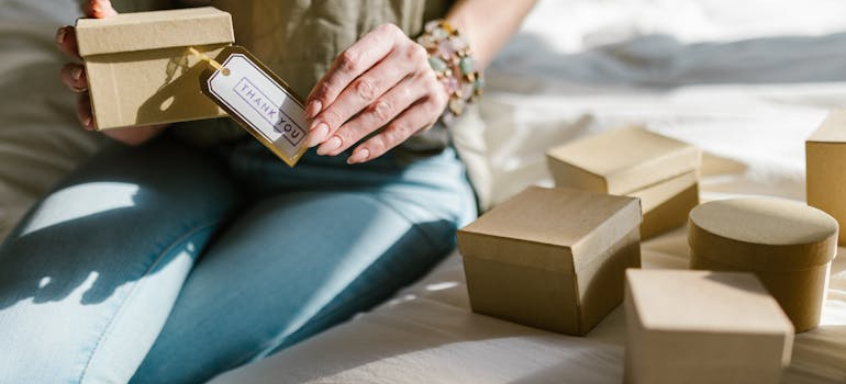 person with their Jewlery boxes layed out on the bed, what most people forget during a rush move is that small boxes like this one get lost quickly