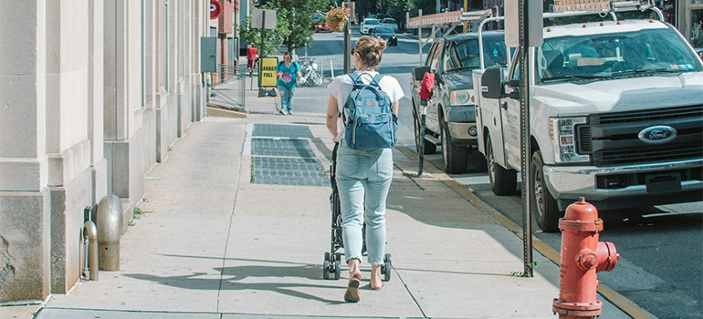 woman walking the streets and thinking about the cost of moving to West Chester