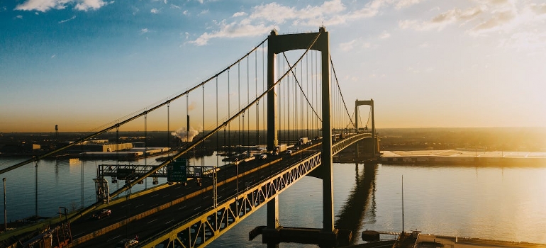 suspension bridge over river in bright sunshine